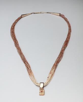 Hand-rolled shell heishi necklace with gold pendant