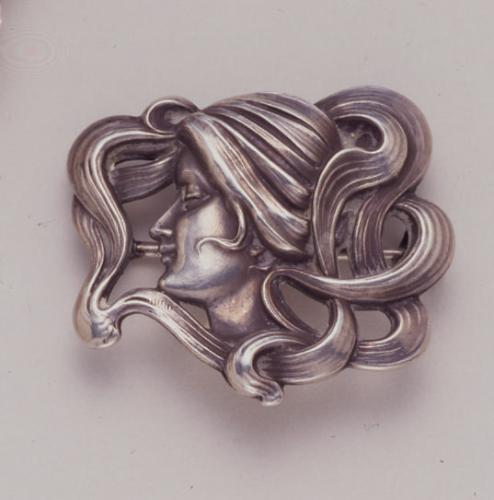 Brooch of woman with swirling hair